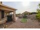 Landscaped backyard with putting green and gravel at 684 S 231St Dr, Buckeye, AZ 85326