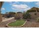 Back patio with desert landscaping and putting green at 684 S 231St Dr, Buckeye, AZ 85326