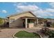 A backyard with a covered patio, a small patch of artificial grass, desert landscaping, and a stucco wall at 684 S 231St Dr, Buckeye, AZ 85326