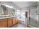 Bathroom with double vanity, soaking tub, and walk-in shower at 684 S 231St Dr, Buckeye, AZ 85326