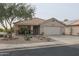 Single-story home with a two-car garage and desert landscaping at 684 S 231St Dr, Buckeye, AZ 85326