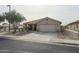 Single-story home with a two-car garage and desert landscaping at 684 S 231St Dr, Buckeye, AZ 85326