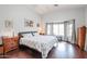 Spacious main bedroom with wood floors and large window at 684 S 231St Dr, Buckeye, AZ 85326