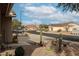 Street view of a neighborhood with houses, desert landscaping, and mountains in the background at 684 S 231St Dr, Buckeye, AZ 85326