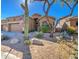 Front view of a tan house with cacti and desert landscaping at 7143 E Canyon Wren Dr, Gold Canyon, AZ 85118