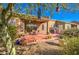 Backyard patio with seating area, surrounded by trees and plants at 7143 E Canyon Wren Dr, Gold Canyon, AZ 85118