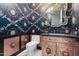 Unique powder room with ornate mirror and artistic wallpaper at 7514 N 22Nd Pl, Phoenix, AZ 85020