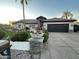 Single-story home with a landscaped yard, large driveway, and a three-car garage at 7514 N 22Nd Pl, Phoenix, AZ 85020