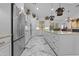 Gourmet kitchen with stainless steel appliances, white cabinets, and marble flooring at 7514 N 22Nd Pl, Phoenix, AZ 85020