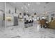 Bright kitchen featuring white cabinets, a large island, and marble floors at 7514 N 22Nd Pl, Phoenix, AZ 85020