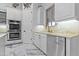 Modern kitchen featuring white cabinets, marble floors and stainless steel appliances at 7514 N 22Nd Pl, Phoenix, AZ 85020