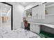 Bright laundry room with white cabinets and built-in workspace at 7514 N 22Nd Pl, Phoenix, AZ 85020