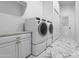 Clean laundry room with washer, dryer, and ample storage at 7514 N 22Nd Pl, Phoenix, AZ 85020