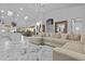 Open concept living area with a large sectional sofa, marble floors, and kitchen views at 7514 N 22Nd Pl, Phoenix, AZ 85020
