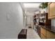 Kitchen with cabinets, shelves, and a hallway leading to another area at 939 W Mission Ln, Phoenix, AZ 85021