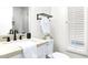 Clean bathroom with white vanity, black fixtures, and a window with shutters at 9559 E Jenan Dr, Scottsdale, AZ 85260