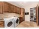 Bright laundry room with modern appliances and cabinets at 11209 E Cavedale Dr, Scottsdale, AZ 85262