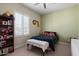 Bedroom with dark blue bedding and a bookshelf at 1310 E Beechnut Pl, Chandler, AZ 85249