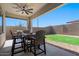 Covered patio with seating area and grassy backyard at 1310 E Beechnut Pl, Chandler, AZ 85249