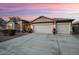 Single-story home with three-car garage and desert landscaping at 13844 W Desert Moon Way, Peoria, AZ 85383