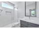 Modern bathroom with white tile shower and gray vanity at 1421 E Weldon Ave, Phoenix, AZ 85014