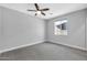 Bright bedroom with gray walls, wood-look tile floors, and a ceiling fan at 1421 E Weldon Ave, Phoenix, AZ 85014