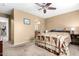 Bedroom with en-suite bathroom access and ceiling fan at 15013 W Ventura St, Surprise, AZ 85379