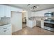 Bright kitchen features white cabinets, stainless steel appliances, and a view into dining area at 1816 N 39Th Ave, Phoenix, AZ 85009