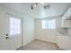 Clean and bright kitchen with white cabinets, door to outside, and tile floor at 1816 N 39Th Ave, Phoenix, AZ 85009