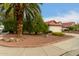 Landscaped yard with a palm tree and rock garden at 18427 N 36Th Ln, Glendale, AZ 85308