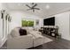 Living room with sectional sofa, large TV, and wood-look floors at 18427 N 36Th Ln, Glendale, AZ 85308