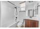Clean bathroom with white tub, toilet and vanity with wood cabinets at 2008 E Stacey Rd, Gilbert, AZ 85298