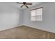 Well-lit bedroom with ceiling fan and neutral decor at 2008 E Stacey Rd, Gilbert, AZ 85298