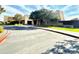 Community center exterior with a paved driveway, landscaping, and trees at 2008 E Stacey Rd, Gilbert, AZ 85298