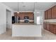 Island kitchen with dark wood cabinets and granite countertops at 2008 E Stacey Rd, Gilbert, AZ 85298