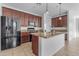 Spacious kitchen with dark wood cabinets and granite countertops at 2008 E Stacey Rd, Gilbert, AZ 85298