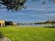 Park with a lake, fountain, green grass, and community buildings at 2008 E Stacey Rd, Gilbert, AZ 85298