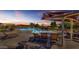 Relaxing community pool with lounge chairs and shade structures at 2008 E Stacey Rd, Gilbert, AZ 85298