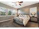 Relaxing bedroom with a plush bed, ceiling fan, and large windows at 2317 W Horsetail Trl, Phoenix, AZ 85085