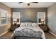 Spacious bedroom with a unique bed frame, decorative wallpaper, and shuttered windows at 2317 W Horsetail Trl, Phoenix, AZ 85085