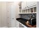 Convenient coffee bar with built-in cabinetry and granite countertops at 2317 W Horsetail Trl, Phoenix, AZ 85085