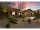 Front exterior of a single-story home with desert landscaping, stone accents, and a two-car garage at 2317 W Horsetail Trl, Phoenix, AZ 85085