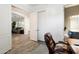 Home office with wood-look flooring, access to a private bathroom, and view of the Gathering room at 2317 W Horsetail Trl, Phoenix, AZ 85085