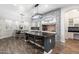 Modern kitchen with dark granite countertops, a large island, and stainless steel appliances at 2317 W Horsetail Trl, Phoenix, AZ 85085