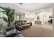 Cozy living room with plush carpeting, plantation shutters, and recessed lighting at 2317 W Horsetail Trl, Phoenix, AZ 85085