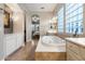 Inviting Primary bath with a jacuzzi tub, double sinks, glass block window, and tile flooring at 2317 W Horsetail Trl, Phoenix, AZ 85085