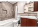 Updated bathroom with a tub, toilet and vanity at 2325 W Orchid Ln, Phoenix, AZ 85021