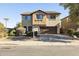 Two-story house with brown garage door and landscaping at 2699 N Daisy Dr, Florence, AZ 85132