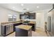 Kitchen with dark cabinets, granite counters and island at 2699 N Daisy Dr, Florence, AZ 85132