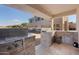 Outdoor kitchen with grill and bar area at 2836 E Dennisport Ct, Gilbert, AZ 85295